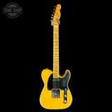 A classic Fender Telecaster electric guitar in a natural yellow wood finish, shown from the front against a solid black background. The guitar features a black pickguard, chrome hardware, and a maple neck with dot inlays.