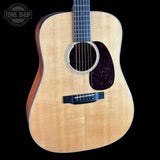 Acoustic guitar with a visible brand logo in the corner