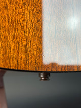 Close-up of a wooden surface with a metal knob
