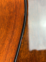 Black cable on a wooden surface with a white paper background