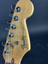 Close-up of a Fender Stratocaster guitar headstock on a dark background
