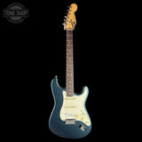 Electric guitar with a blue body and white pickguard on a black background, featuring 'Tone Shop' branding.