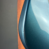 Close-up of a blue ceramic plate with a wooden base