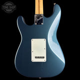 Blue electric guitar with Fender logo on a black background