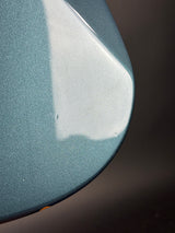 Close-up of a textured blue surface with a dark background