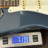 Guitar on a digital scale displaying weight