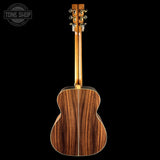 Wooden acoustic guitar on a black background with 'Tone Shop' logo.