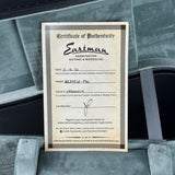 Eastman Certificate of Authenticity for a musical instrument on a gray background