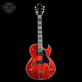 Red electric guitar with a black background