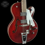 Red electric guitar with Gretsch logo on a black background
