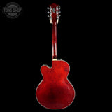 Red electric guitar on a black background with 'Tone Shop' logo.