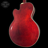 Red electric guitar body on a black background with 'Tone Shop' logo.