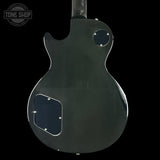 Back view of a black electric guitar on a transparent background with 'Tone Shop' logo.