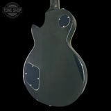 Glossy black electric guitar body on a white background with 'Tone Shop' logo.