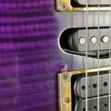 Close-up of a purple electric guitar with metallic parts