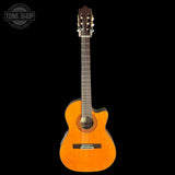 Acoustic guitar with a cutaway on a black background, featuring the Tone Shop logo.