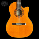 Acoustic guitar with a visible brand logo on a black background