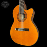 Acoustic guitar with a visible brand logo on a black background