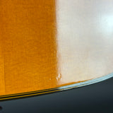 Close-up of a fabric with a textured orange pattern on a metallic surface.