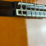 Close-up of a guitar's soundhole and strings on a wooden surface