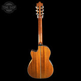 Wooden guitar with a cutaway design on a black background, featuring 'Tone Shop' branding.