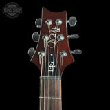 Guitar headstock with brand logo on a black background