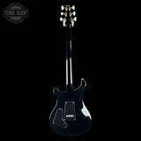 A glossy black electric guitar shown from the back against a solid black background, with a Tone Shop watermark in the upper left corner.