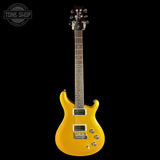 Yellow electric guitar on a black background with 'Tone Shop' logo.