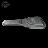 A black guitar headstock hard case with a silver logo, shown from a side profile against a solid black background. A Tone Shop watermark is visible in the top-left corner.