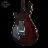Glossy electric guitar body with visible brand logo on a black background