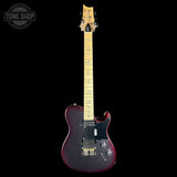 A double-cutaway electric guitar with a dark purple glitter finish, maple neck, and gold hardware, shown against a solid black background with a Tone Shop watermark in the top left corner.