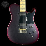 A close-up of a Fender Telecaster-style electric guitar body with a dark purple-to-red glitter finish, black pickguard, maple neck, and gold hardware, shown against a black background with a Tone Shop watermark in the upper left.