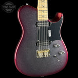 A close-up of a Fender Telecaster electric guitar body with a dark purple glitter finish and a black pickguard, shown against a black background with a Tone Shop watermark in the top left corner.