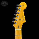 Guitar headstock with Fender logo on a black background