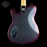 Close-up of the back of aPRS guitars electric guitar body, featuring a dark purple-to-black glitter finish with a maple neck and a black pickguard, set against a solid black background.