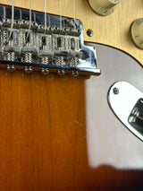 Close-up of a guitar's bridge and part of the body