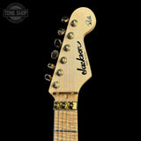 Guitar headstock with 'Jackson' branding on a black background