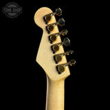 Guitar headstock with tuning pegs on a black background, featuring 'Tone Shop' logo.