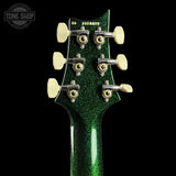 Close-up of the headstock of a green glitter electric guitar on a black background, showing six tuners and cream-colored tuning pegs. The model name 'S10 88RTS' is printed on the headstock.