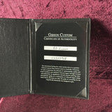 Gibson Custom Certificate of Authenticity on a textured red surface