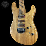 Wooden electric guitar on a black background with 'Tone Shop' logo.
