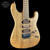 Wooden electric guitar with a visible brand logo on a black background