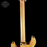 Close-up of a guitar neck and headstock on a black background with 'Tone Shop' logo.