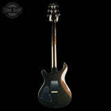 A dark metallic glitter electric guitar shown from the back against a solid black background, featuring a TONE SHOP watermark in the upper left corner.