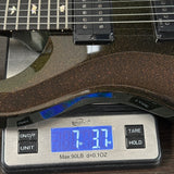 Close-up of an electric guitar body resting on a digital scale displaying 7.37 lbs.