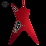 A red star-shaped electric guitar body with a glitter finish, featuring a silver control plate with three white knobs and a black pickup, shown against a solid black background.