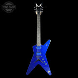 A blue electric guitar with a distinctive V-shaped body, shown vertically against a solid black background. The brand logo 'TONE SHOP' is visible in the top-left corner.