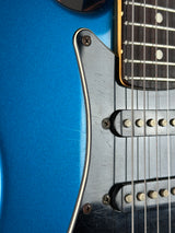 Close-up of a blue electric guitar's neck and body