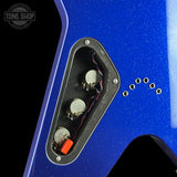 Close-up of a blue electric guitar body showing the open three-potter volume control cavity with silver potentiometers, red and black wiring, and mounting holes, on a black background with a Tone Shop watermark.