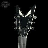Close-up of a black electric guitar headstock with a white wing logo and the word 'DEAD' on a black background. A Tone Shop watermark is visible in the top-left corner.